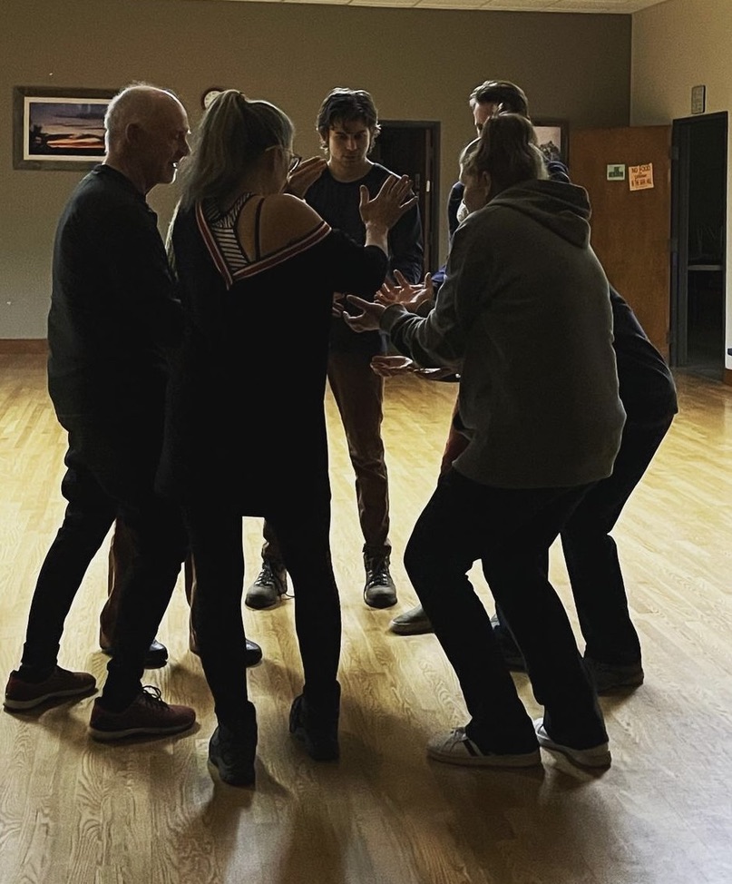 BIC ensemble in a tight huddle during a training exercise